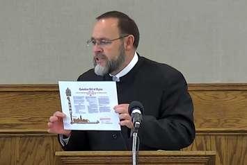 Church of God Pastor Henry Hildebrandt holds up the Canadian Bill of Rights at a service on May 2, 2021. Screen capture from Hildebrandt's YouTube channel. 