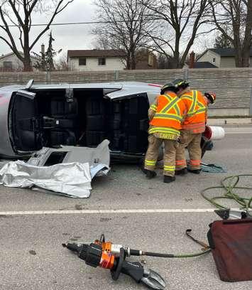 London firefighters cut the roof off of a vehicle that ended up on its side during a crash on Hyde Park Road. December 5, 2022. Photo via @LdnOntFire on Twitter.