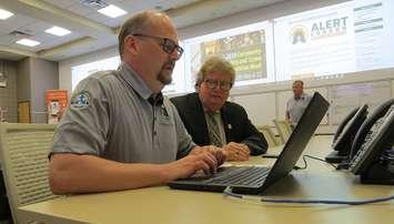 Andre Beauregard of London's emergency management department assists Mayor Ed Holder sign up for the alert London notification system, May 6, 2019. (Photo by Miranda Chant, Blackburn News) 